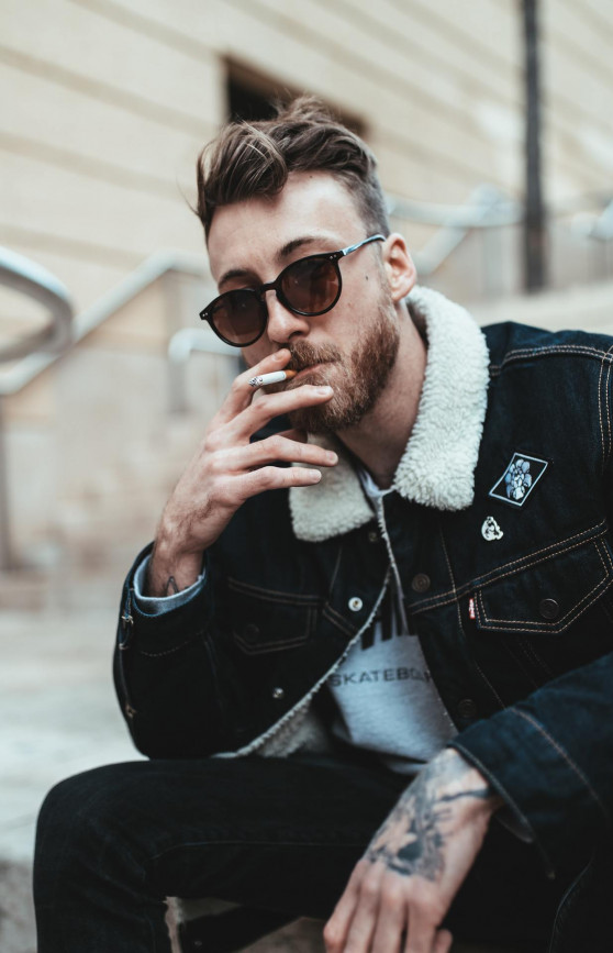 Steve smokes a cigarette.